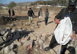 Police investigate the area where Aitzaz had wrestled the suicide bomber to the ground and where both died in the explosion.